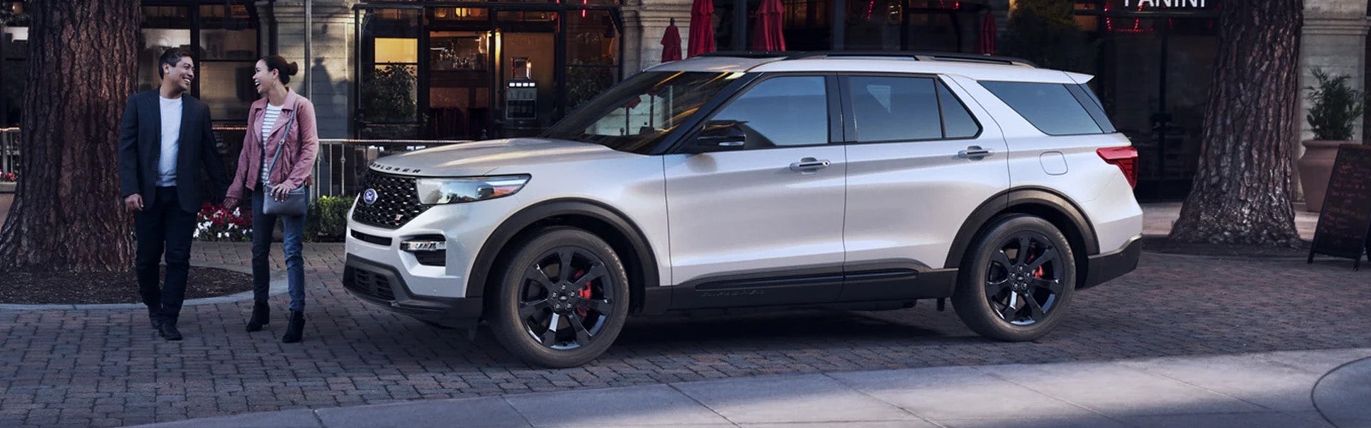 2022 Ford Explorer parked on city street as a couple walks by