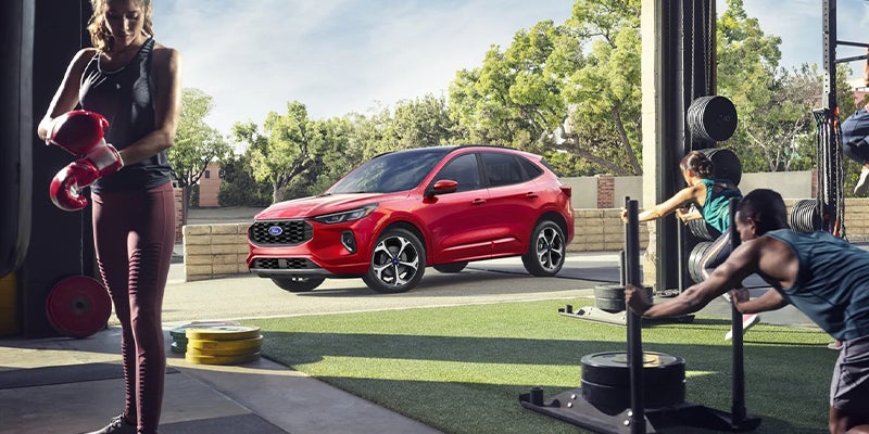 Red 2023 Ford Escape near a modern buildin