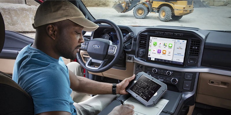 Person using a tablet while seated inside the F-150.