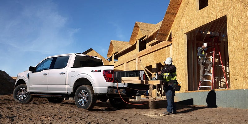 White F-150 parked at a home construction site