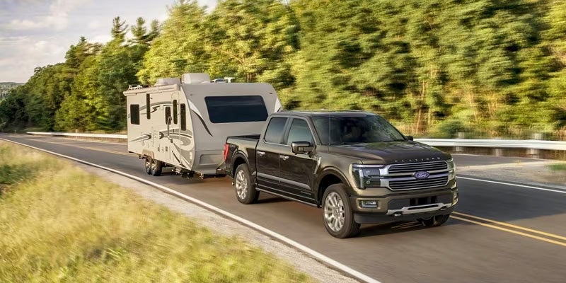 F-150 towing a camper on a highway