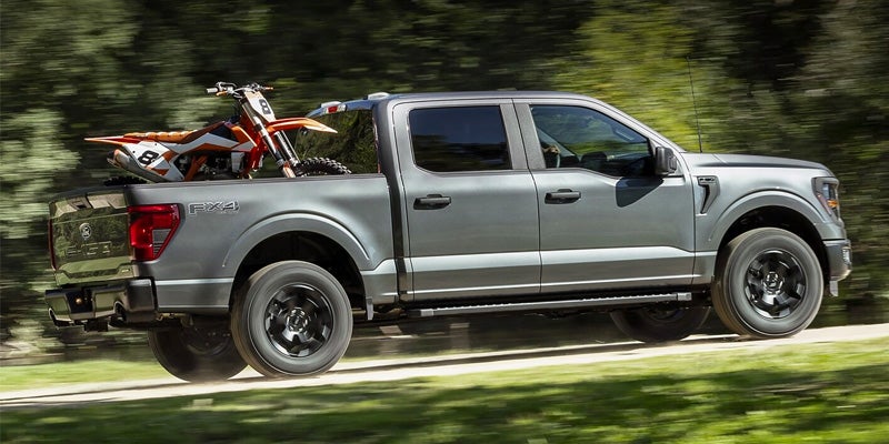 Silver F-150 hauling off-road gea