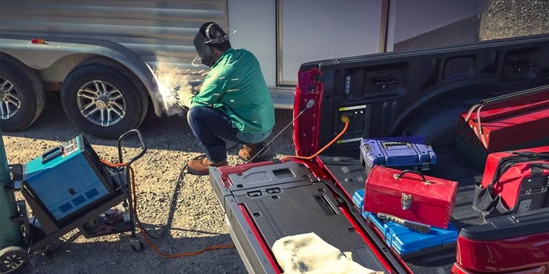 Man using tools from the F-150’s open tailgate