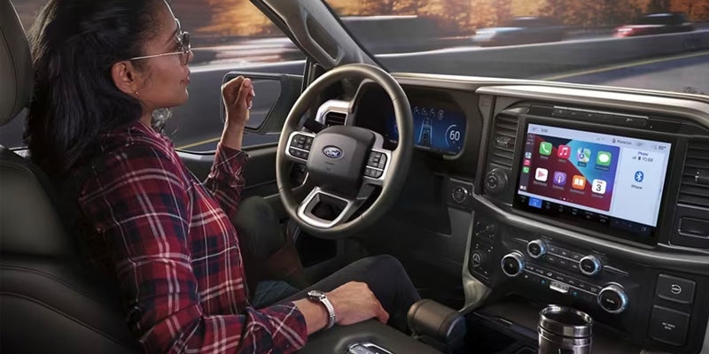 Man in flannel using the vehicle’s touchscreen