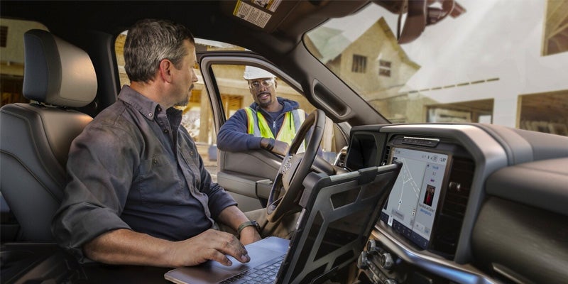 Man working on a laptop inside the parked F-15